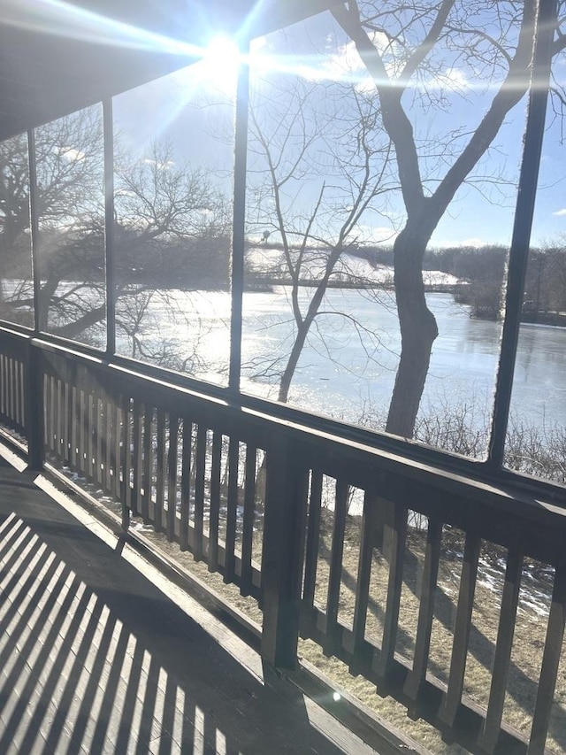 unfurnished sunroom with a water view