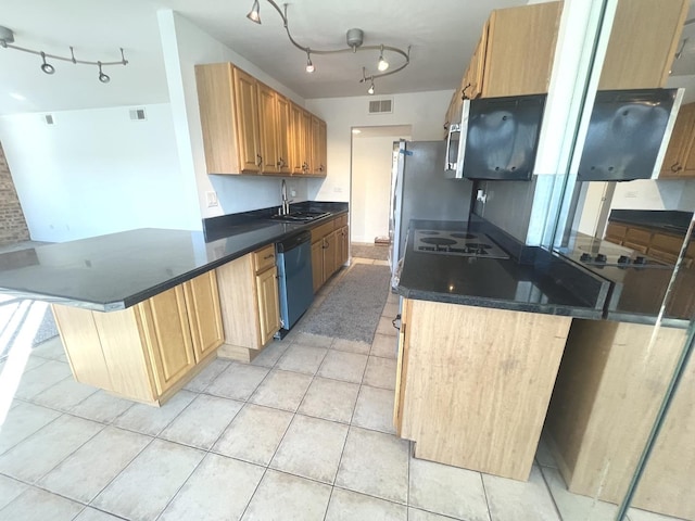 kitchen with light tile patterned floors, appliances with stainless steel finishes, kitchen peninsula, and sink