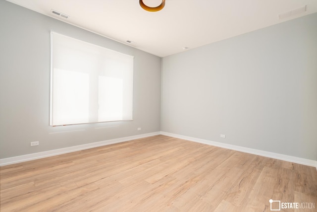 unfurnished room with light hardwood / wood-style floors