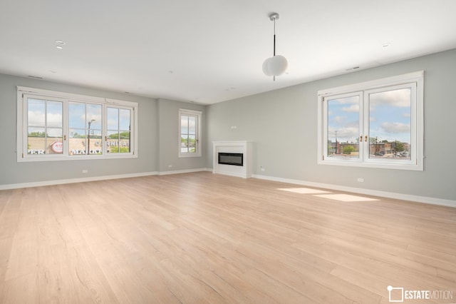 unfurnished living room with light hardwood / wood-style flooring