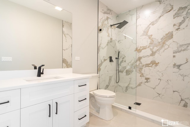 bathroom featuring toilet, vanity, and tiled shower