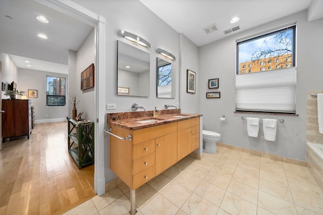 bathroom featuring tile patterned flooring, vanity, and toilet