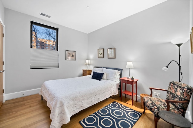 bedroom with wood-type flooring