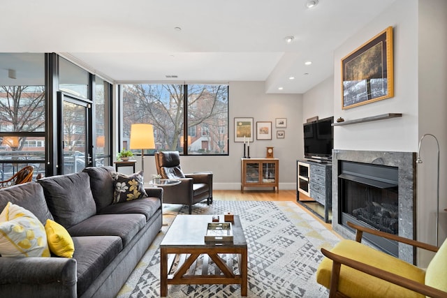 living room with floor to ceiling windows and light wood-type flooring