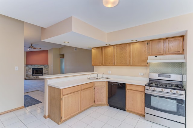 kitchen featuring dishwasher, light countertops, gas stove, and under cabinet range hood