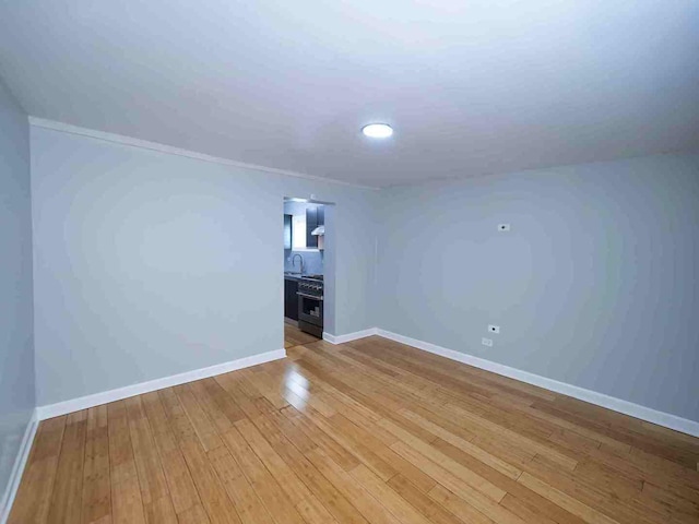 unfurnished room featuring light hardwood / wood-style flooring and sink