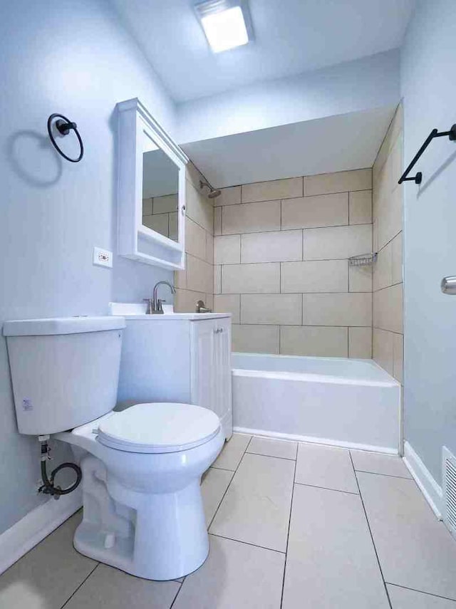 full bathroom featuring toilet, tiled shower / bath combo, tile patterned flooring, and sink