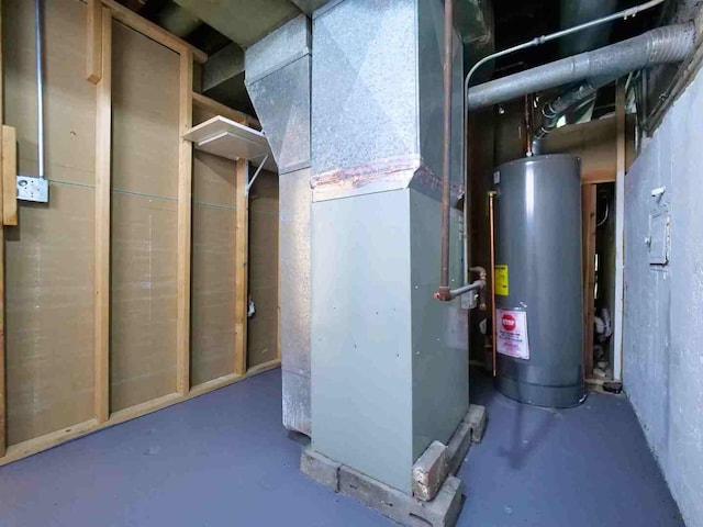 utility room featuring heating unit and gas water heater