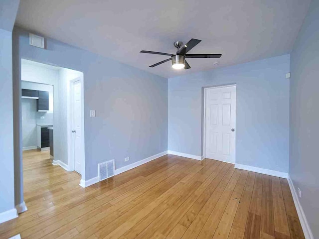 unfurnished room featuring ceiling fan and light wood-type flooring