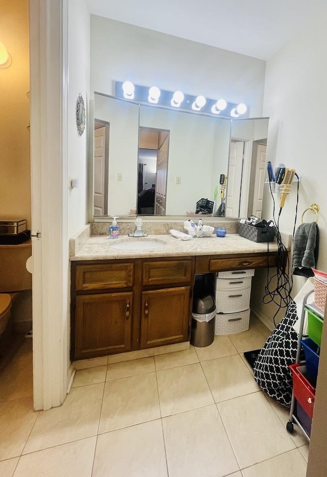 bathroom with toilet, tile patterned flooring, and vanity