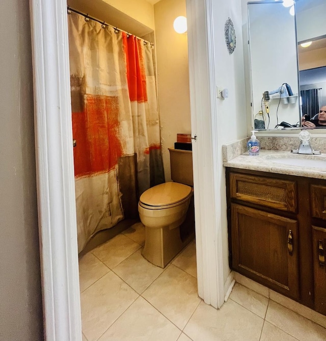 bathroom featuring toilet, tile patterned floors, and vanity