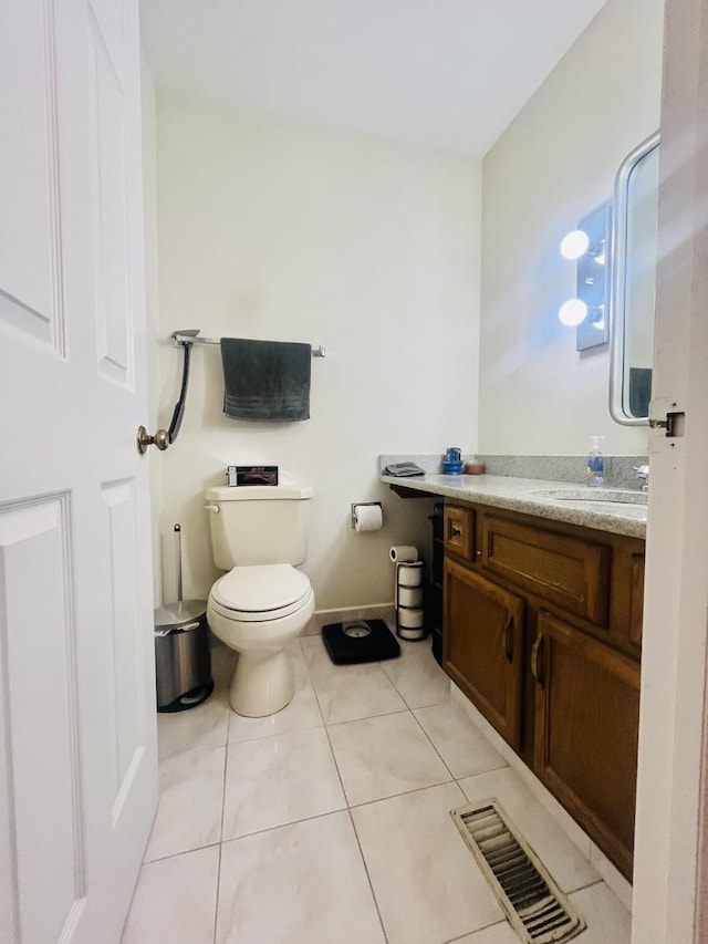 bathroom featuring toilet, vanity, and tile patterned floors