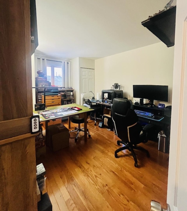 home office with wood-type flooring