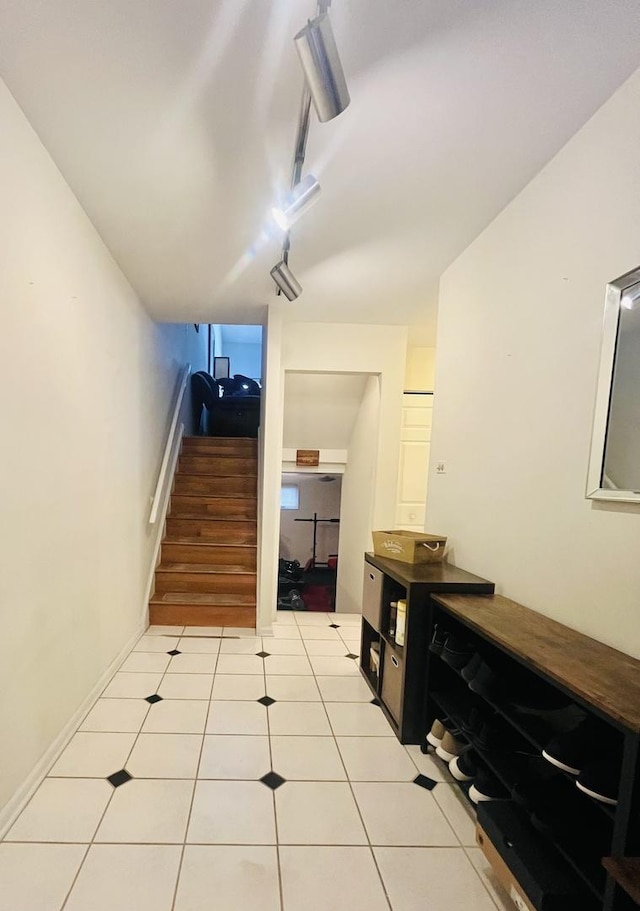 stairway featuring tile patterned flooring