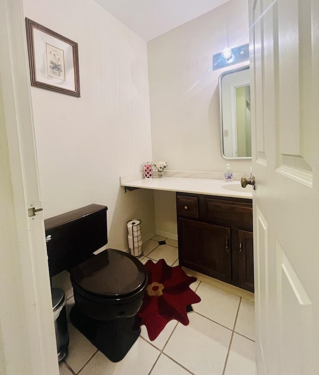 bathroom featuring toilet, tile patterned floors, and vanity