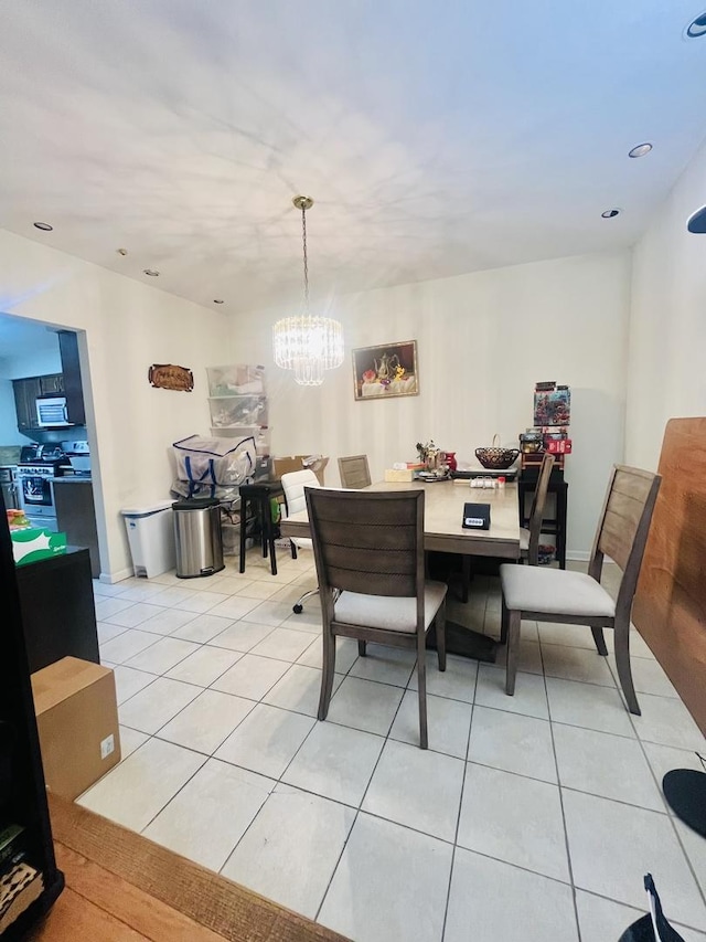 dining area featuring an inviting chandelier and light tile patterned flooring