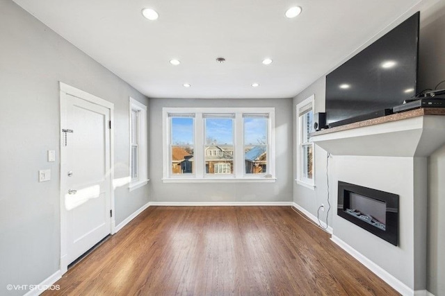 unfurnished living room with wood-type flooring