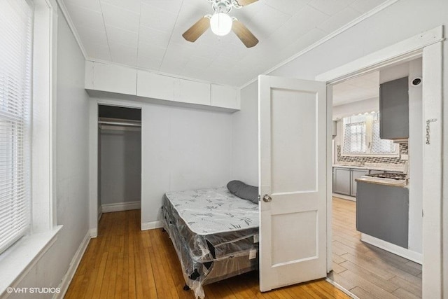 bedroom with ceiling fan, a closet, and light wood-type flooring