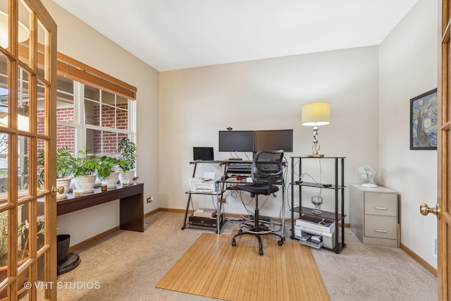 office space with baseboards and light colored carpet