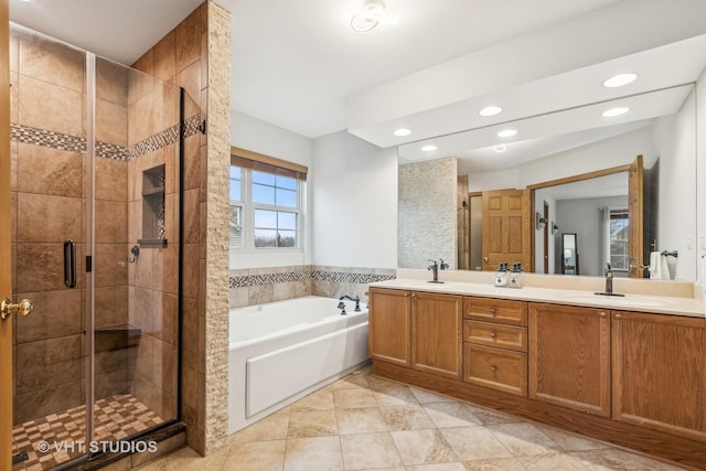 full bathroom with recessed lighting, a sink, a shower stall, a bath, and double vanity