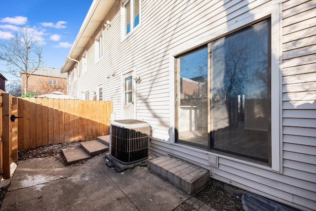 view of side of property featuring a patio area and cooling unit