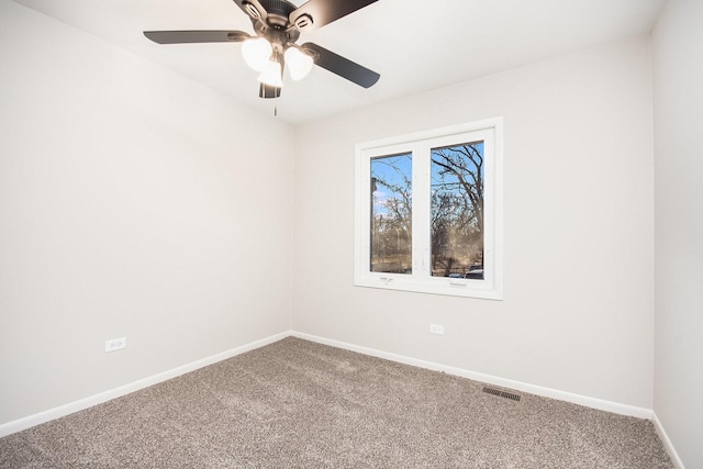 spare room with ceiling fan and carpet