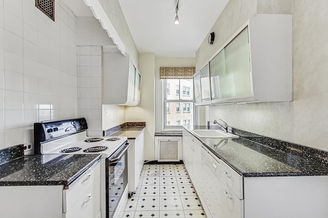 kitchen featuring rail lighting, sink, white cabinetry, white dishwasher, and range with electric cooktop