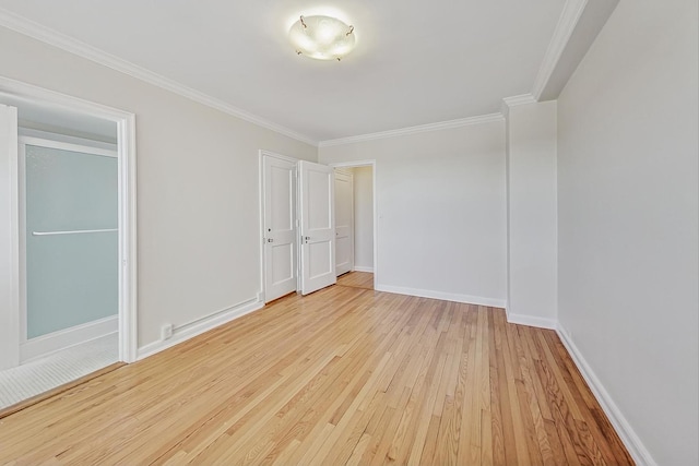 unfurnished room with ornamental molding and light hardwood / wood-style floors