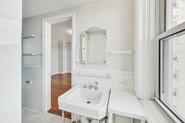 bathroom with sink and tile walls