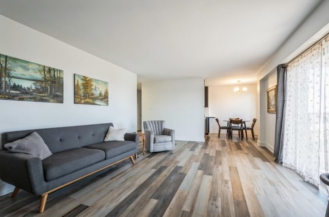 living room with wood-type flooring and a notable chandelier