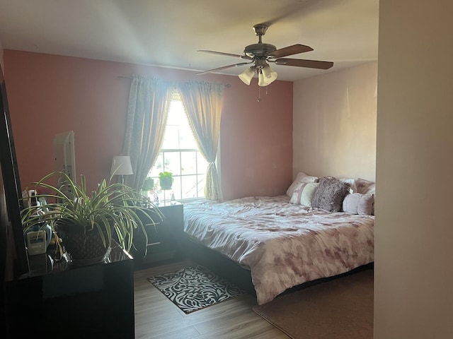 bedroom with ceiling fan and light hardwood / wood-style flooring