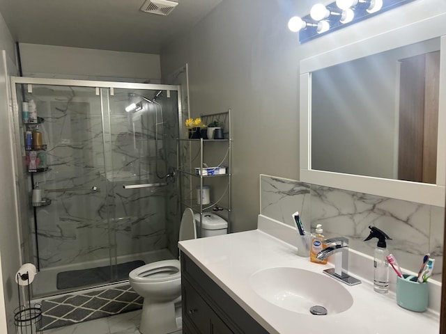 bathroom with backsplash, toilet, vanity, and an enclosed shower