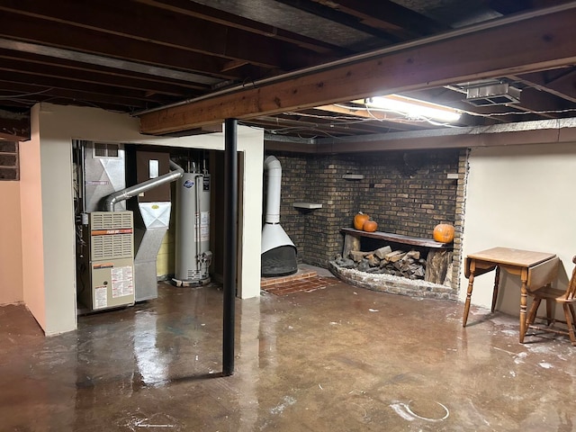 basement with heating unit, brick wall, and gas water heater