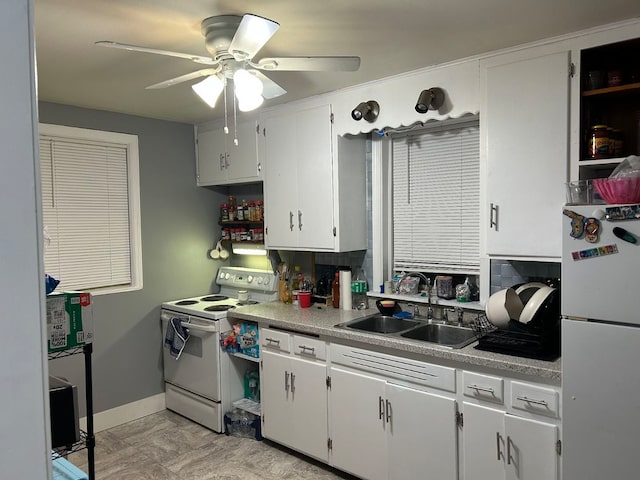 kitchen featuring ceiling fan, sink, white cabinets, and white appliances