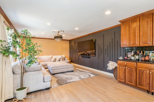 living room featuring light wood-type flooring and ornamental molding