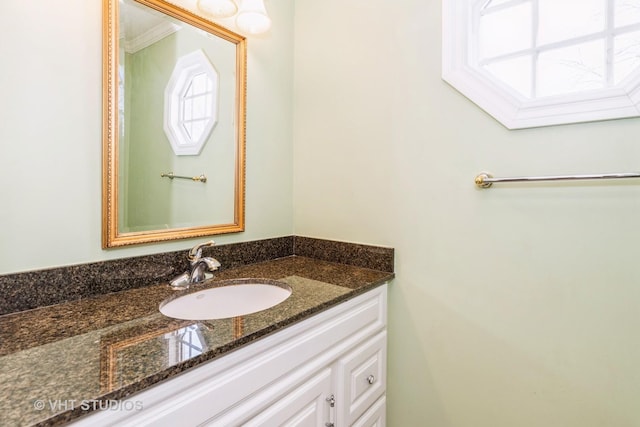 bathroom with crown molding and vanity