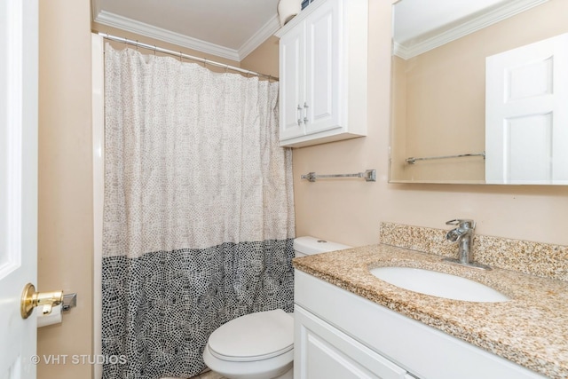 bathroom with toilet, vanity, and ornamental molding