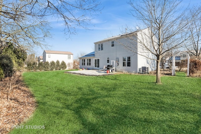 back of house featuring central air condition unit, a patio area, and a yard