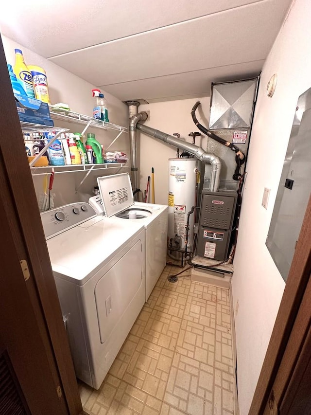 clothes washing area featuring water heater and washer and clothes dryer