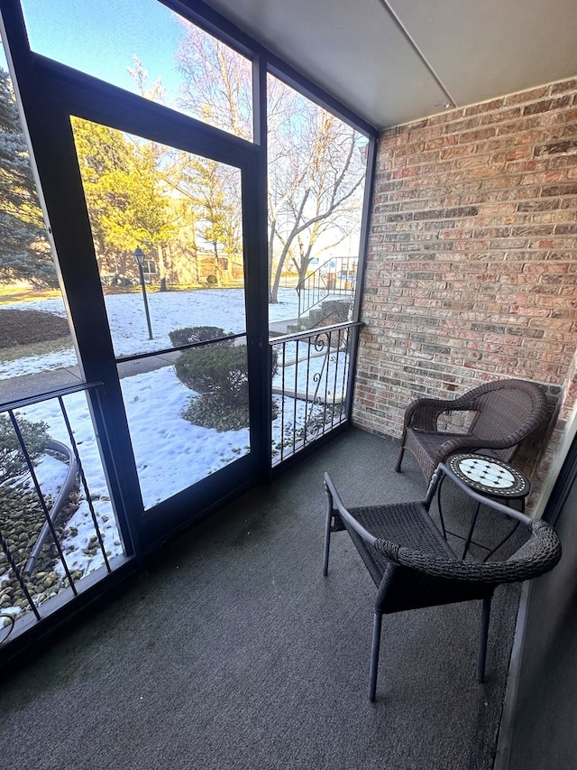 unfurnished sunroom featuring a water view