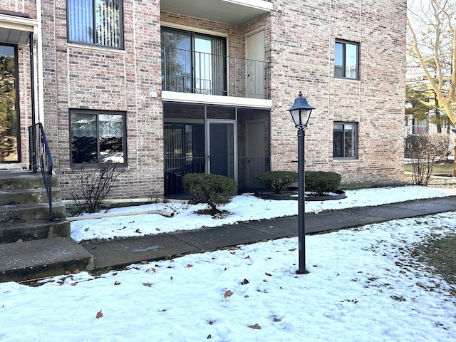 view of snow covered property entrance