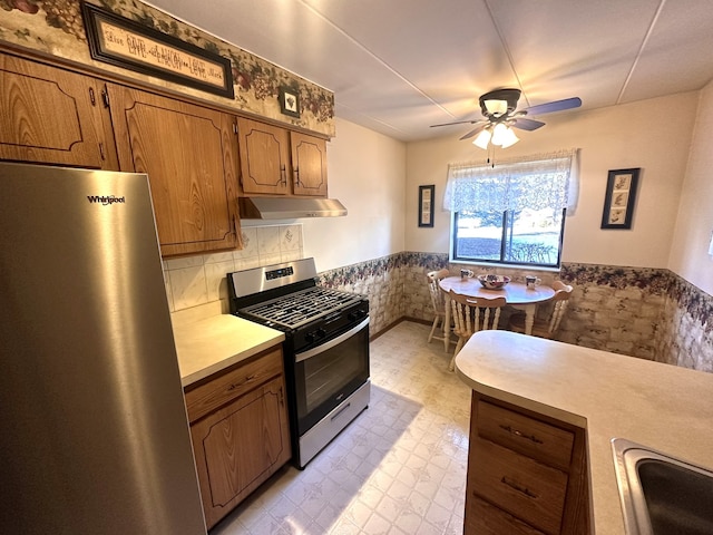 kitchen featuring ceiling fan, sink, and stainless steel appliances