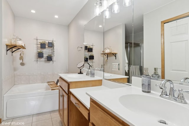 bathroom featuring a tub to relax in, tile patterned flooring, and vanity