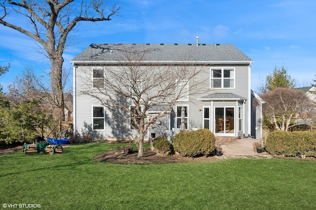 back of property with a patio and a lawn