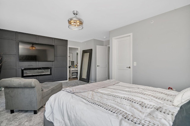 bedroom featuring a large fireplace