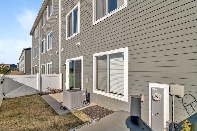 exterior space featuring a patio, cooling unit, and a lawn