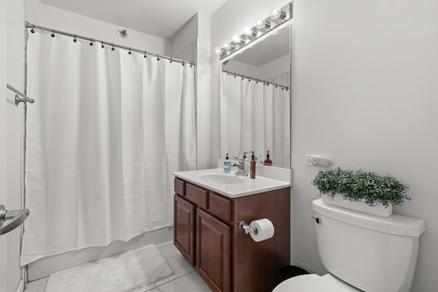 bathroom featuring toilet, vanity, tile patterned floors, and a shower with shower curtain