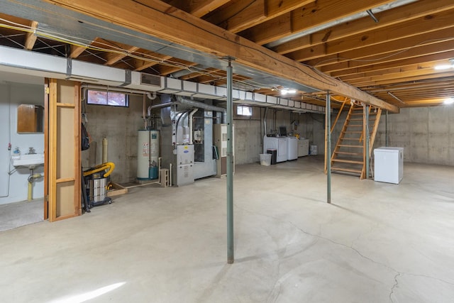 basement with washer / clothes dryer, gas water heater, fridge, and sink