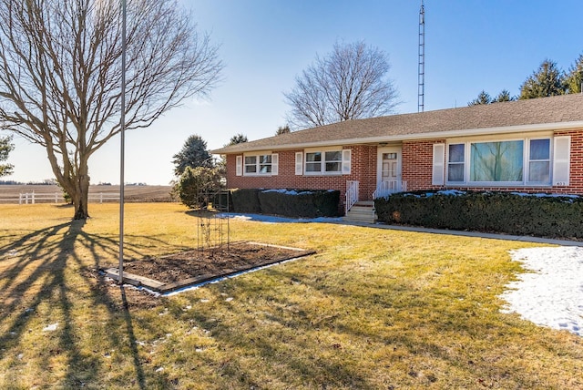 single story home featuring a front lawn