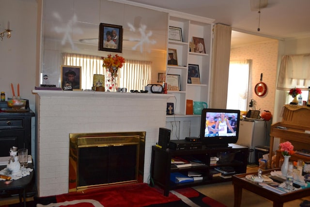 living room featuring a brick fireplace and ornamental molding